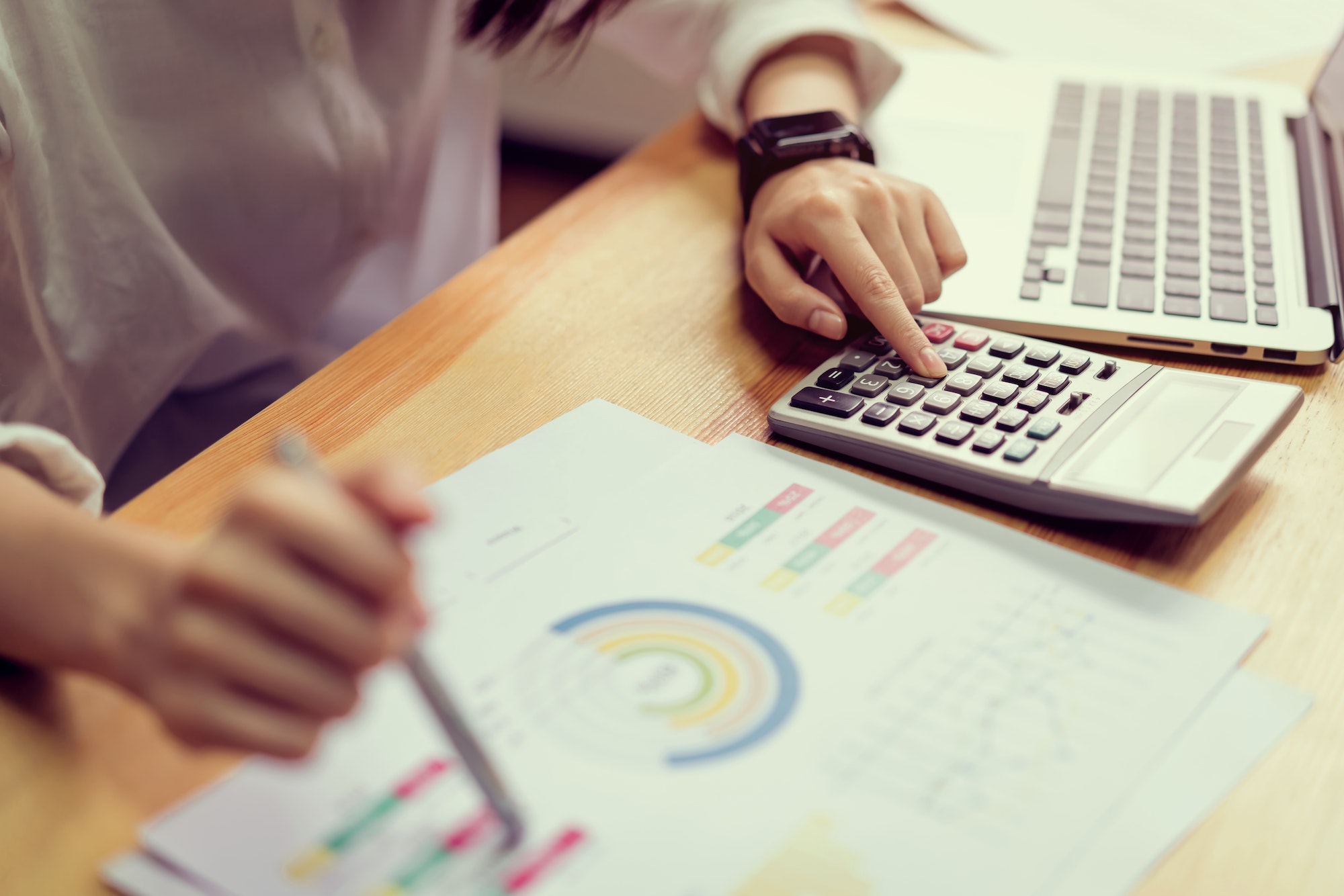 Businesswoman in office and use computer and calculator to perform financial accounting