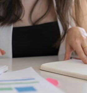 Close up Businessman using calculator and laptop for calaulating finance, tax, accounting